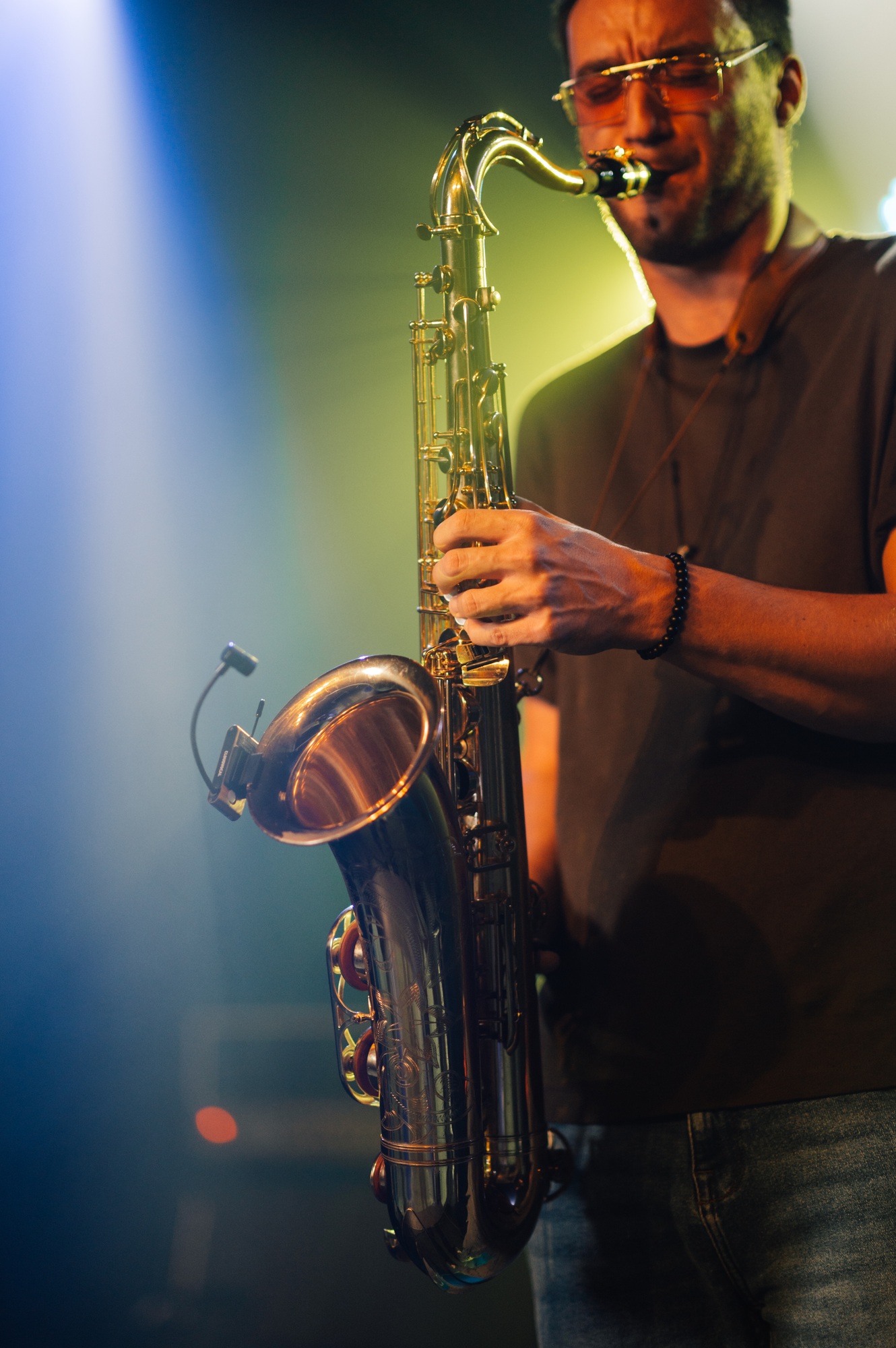 Saxophonist playing sax on stage during live performance